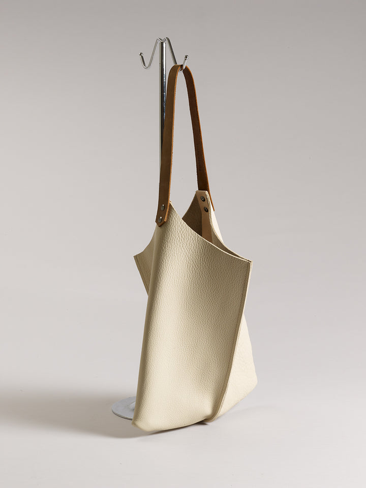 Cream bullhide handbag with architectural form