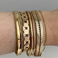 Stack of vintage 14k gold bracelets from Scabby Robot shop