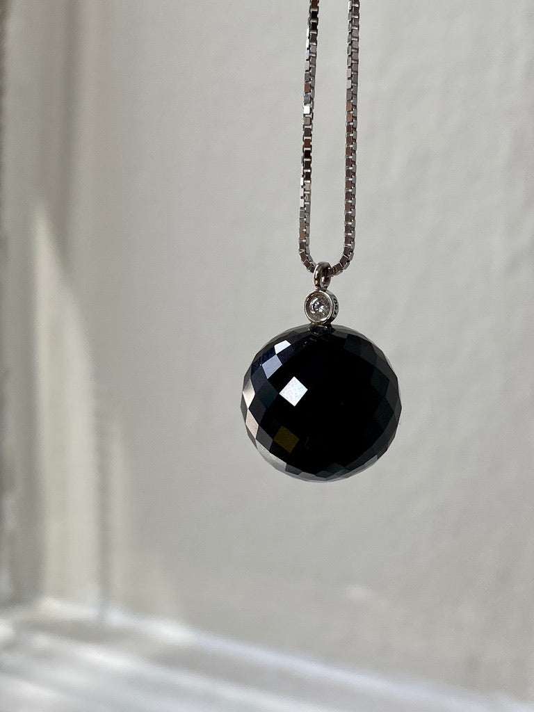 Brilliant! Black onyx faceted orb pendant necklace set in 18k white gold with 0.05 ct brilliant cut diamond by Ole Lynggaard