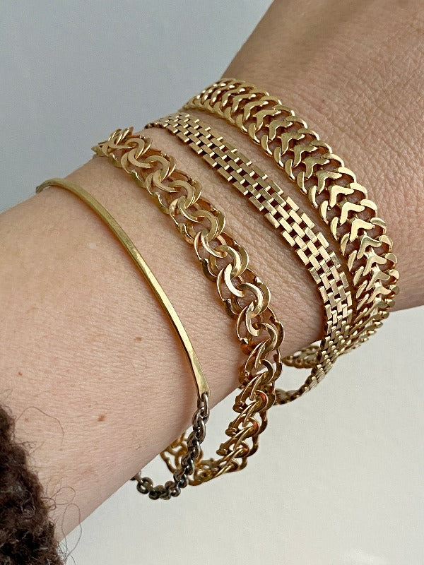 stack of 4 18k gold bracelets. One is contemporary and three are vintage bracelets from Sweden.