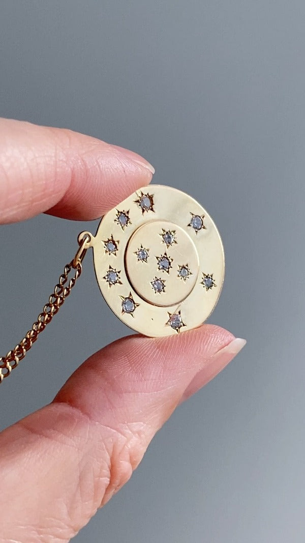 13 stone stars in circles within a solid 18k gold pendant