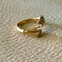 A symbol of affection, a gold hug for your hand. Yellow solid 18k gold vintage embrace ring. Crisp hallmarks for maker and gold purity. Size 8